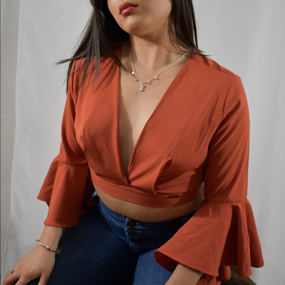 Super cute top with bell shaped sleeves!